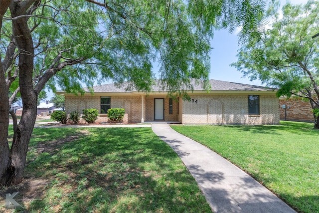 single story home featuring brick siding and a front yard