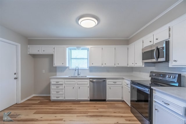 kitchen with white cabinetry, appliances with stainless steel finishes, and a sink