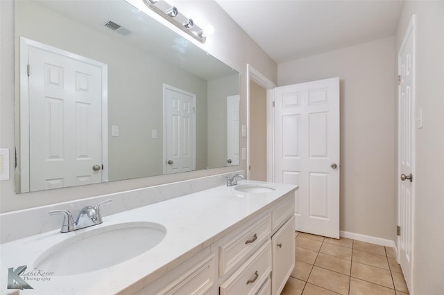 full bath with a sink, tile patterned flooring, double vanity, and visible vents