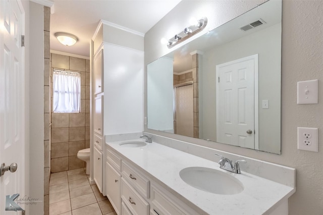 full bathroom featuring a sink, double vanity, toilet, tile patterned floors, and visible vents