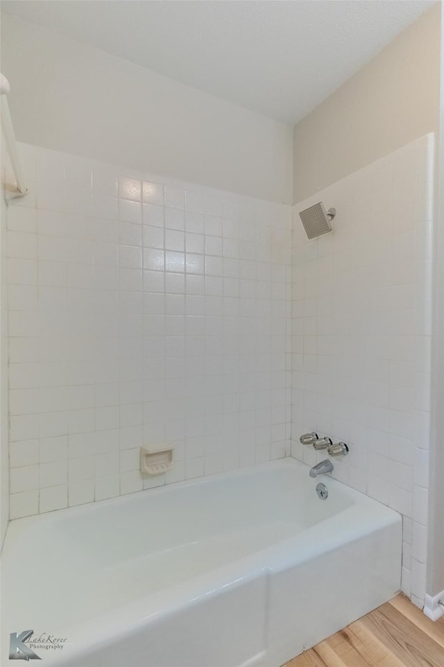 full bath with tub / shower combination and wood finished floors
