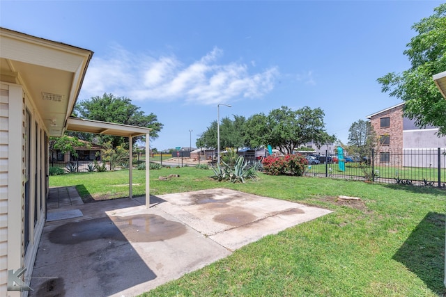 view of yard with a patio, a fenced backyard, and a playground