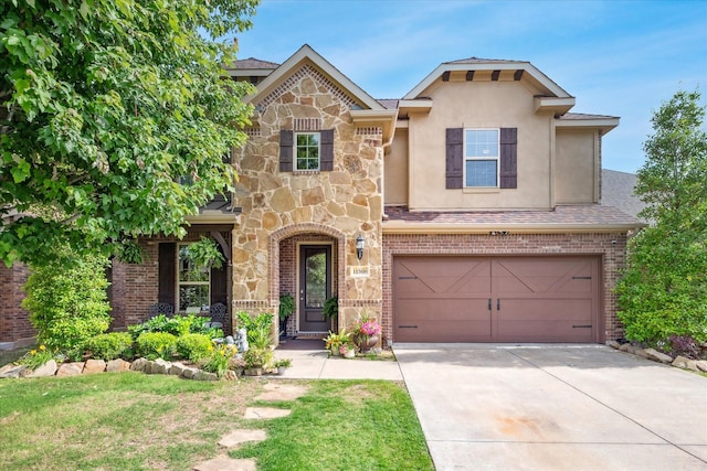 11308 Hubbard Creek Dr, Frisco, TX 75036 - view of front of house featuring stucco siding, a garage, concrete driveway, brick siding, and stone siding