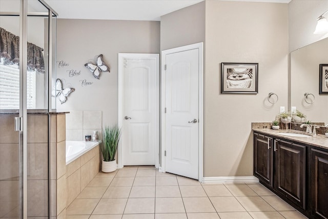 11308 Hubbard Creek Dr, Frisco, TX 75036 - bathroom with vanity, tile patterned floors, a bath, a stall shower, and baseboards