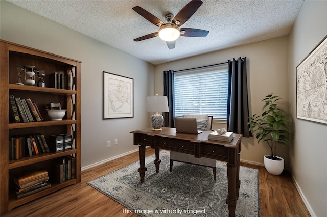 2909 Chisholm Trl, Corinth, TX 76210 - home office with a ceiling fan, wood finished floors, baseboards, and a textured ceiling