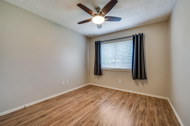 2909 Chisholm Trl, Corinth, TX 76210 - empty room featuring a ceiling fan, wood finished floors, a textured ceiling, and baseboards