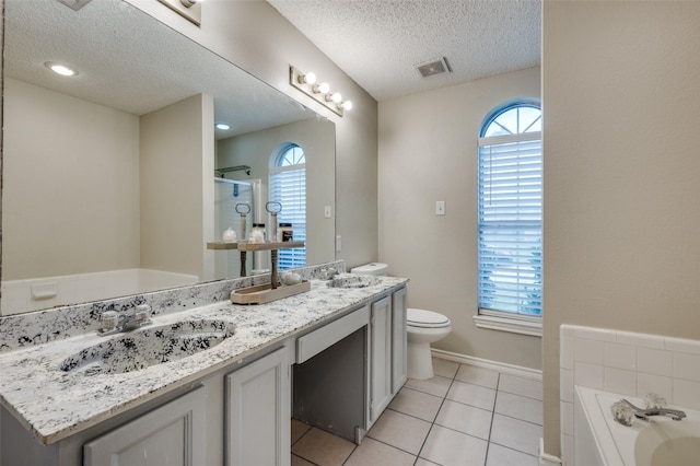 2909 Chisholm Trl, Corinth, TX 76210 - bathroom featuring toilet, plenty of natural light, a stall shower, a textured ceiling, and a bath