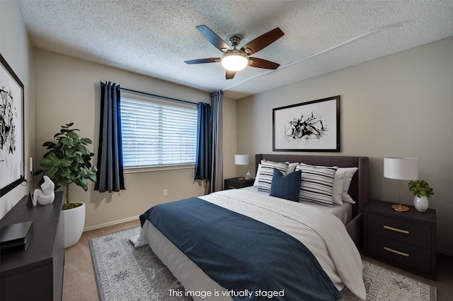 2909 Chisholm Trl, Corinth, TX 76210 - bedroom with carpet floors, a textured ceiling, baseboards, and a ceiling fan