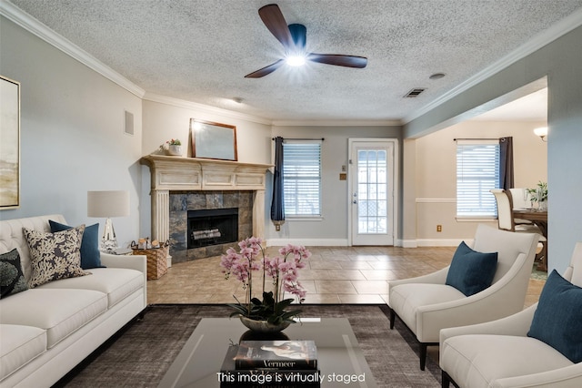 2909 Chisholm Trl, Corinth, TX 76210 - living area featuring a textured ceiling, plenty of natural light, ceiling fan, crown molding, and a fireplace