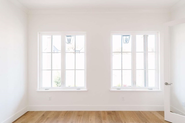 unfurnished room featuring light wood-style floors and baseboards