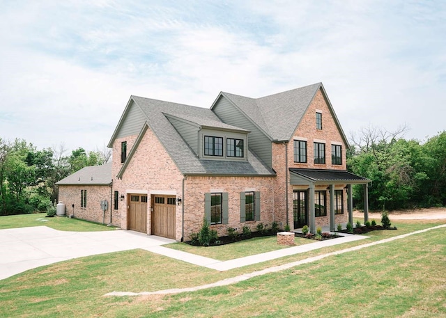 craftsman-style home featuring a shingled roof, driveway, a front lawn, and brick siding