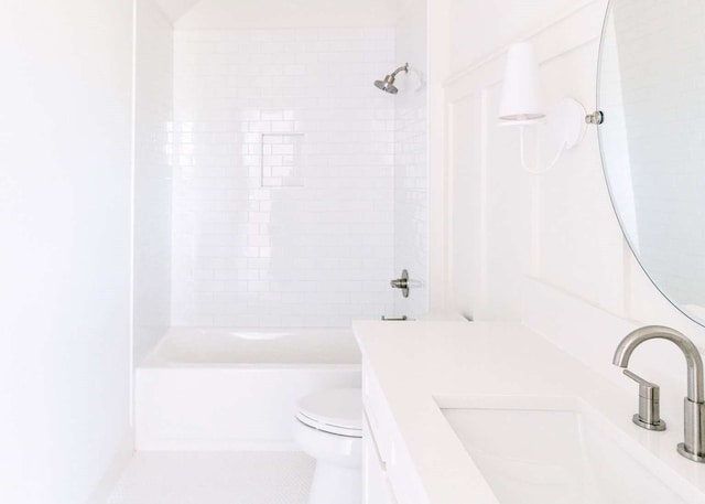 bathroom with vanity, toilet, and shower / tub combination