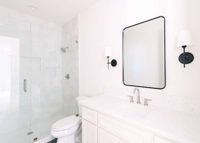full bath featuring vanity, a stall shower, and toilet