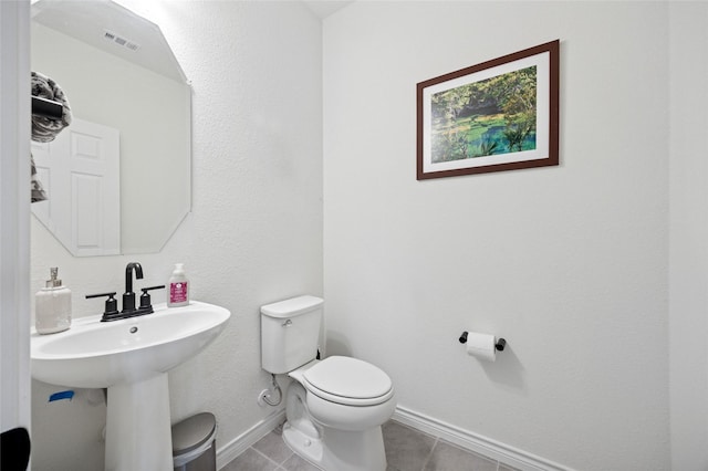 bathroom with visible vents, tile patterned flooring, a sink, baseboards, and toilet
