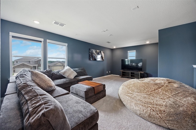 living area featuring plenty of natural light, carpet flooring, recessed lighting, and visible vents