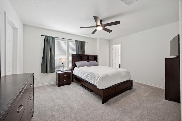 bedroom with visible vents, a ceiling fan, baseboards, and light colored carpet