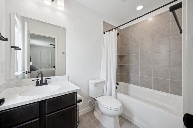 bathroom featuring connected bathroom, vanity, toilet, tile patterned floors, and shower / bath combo with shower curtain