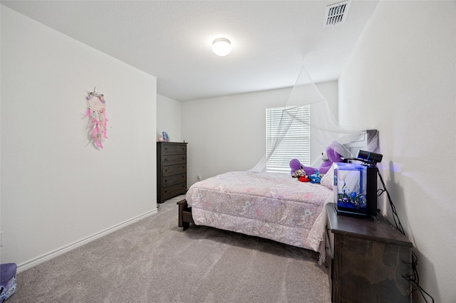 carpeted bedroom with baseboards and visible vents