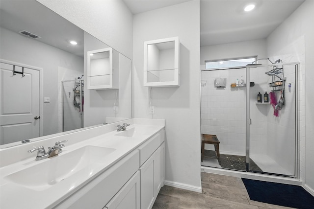 8557 Big Apple Dr, Fort Worth, TX 76179 - bathroom featuring a sink, wood finished floors, visible vents, a stall shower, and baseboards