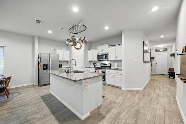 8557 Big Apple Dr, Fort Worth, TX 76179 - kitchen featuring light wood-style flooring, baseboards, visible vents, a sink, and stainless steel appliances