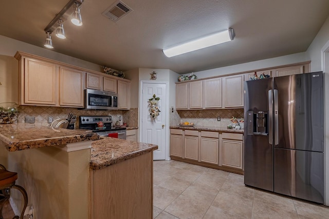415 Oak Leaf Dr, Duncanville, TX 75137 - kitchen with visible vents, decorative backsplash, a peninsula, appliances with stainless steel finishes, and light tile patterned floors