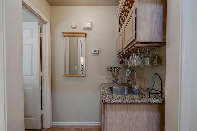 415 Oak Leaf Dr, Duncanville, TX 75137 - bar with baseboards, a sink, and wood finished floors