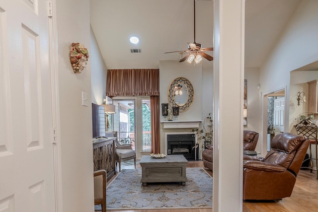 415 Oak Leaf Dr, Duncanville, TX 75137 - living area featuring a fireplace, high vaulted ceiling, a ceiling fan, wood finished floors, and visible vents