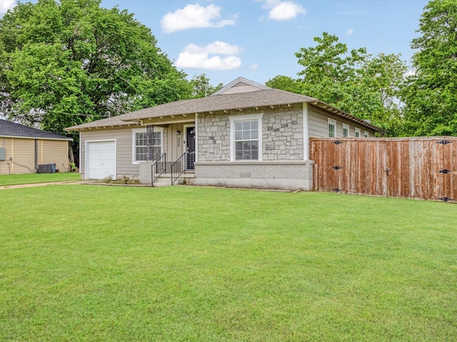 view of front of home featuring an attached garage, fence, a front yard, and concrete driveway