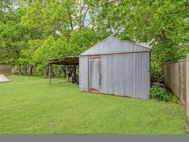 view of pole building featuring fence and a yard