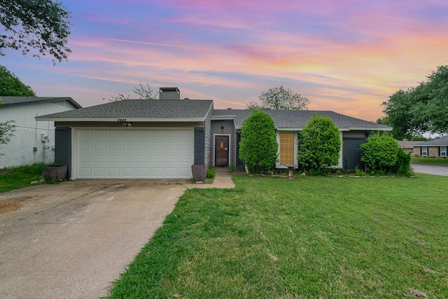 view of front of property featuring a shingled roof, a garage, a chimney, a lawn, and driveway
