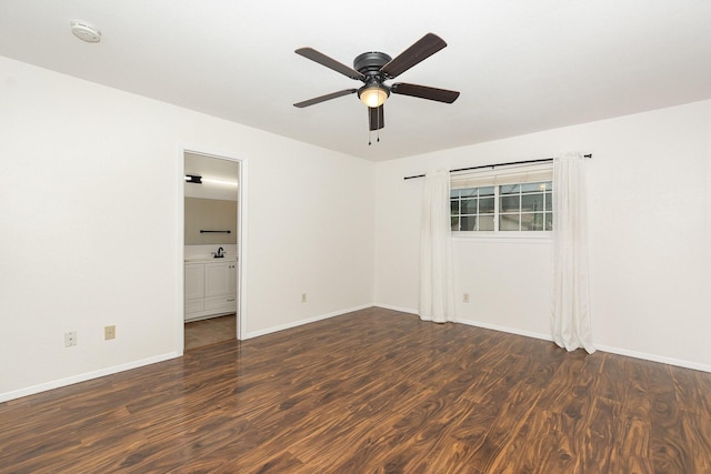 empty room with a ceiling fan, baseboards, a sink, and wood finished floors