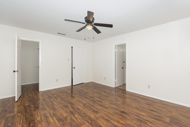 unfurnished bedroom featuring ceiling fan, baseboards, visible vents, and wood finished floors