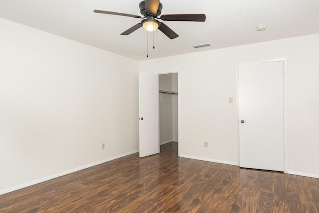 unfurnished bedroom with ceiling fan, baseboards, wood finished floors, visible vents, and a closet