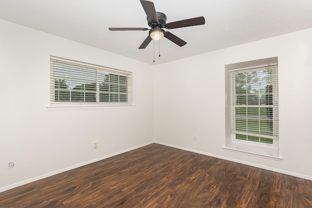 spare room featuring a ceiling fan, baseboards, and wood finished floors