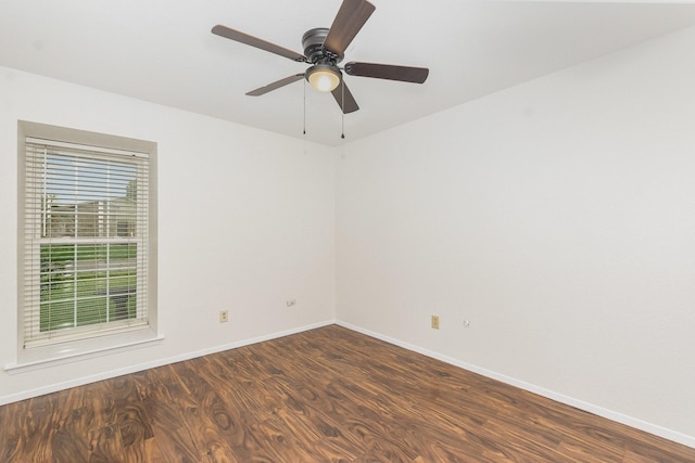 unfurnished room with dark wood-style flooring, baseboards, and ceiling fan
