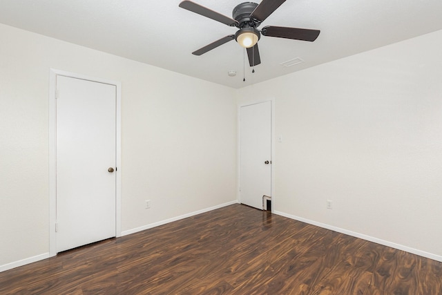 unfurnished bedroom with baseboards, ceiling fan, wood finished floors, and visible vents