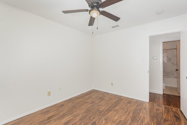 unfurnished room with baseboards, ceiling fan, visible vents, and wood finished floors