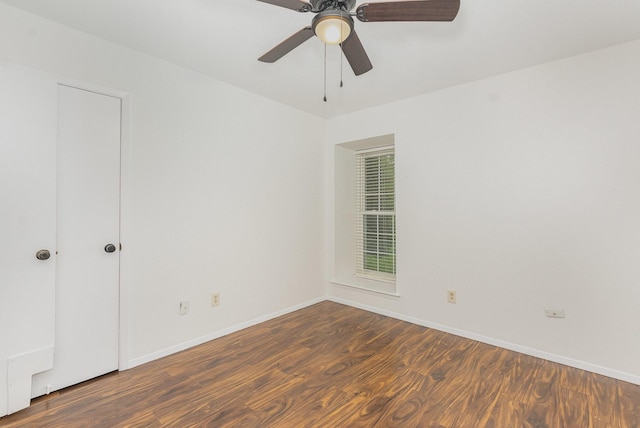 empty room with baseboards, a ceiling fan, and wood finished floors