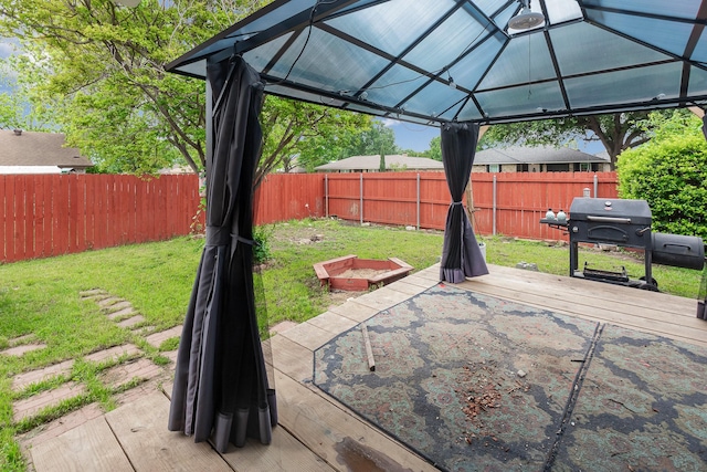 view of yard with a fenced backyard, a wooden deck, and a gazebo