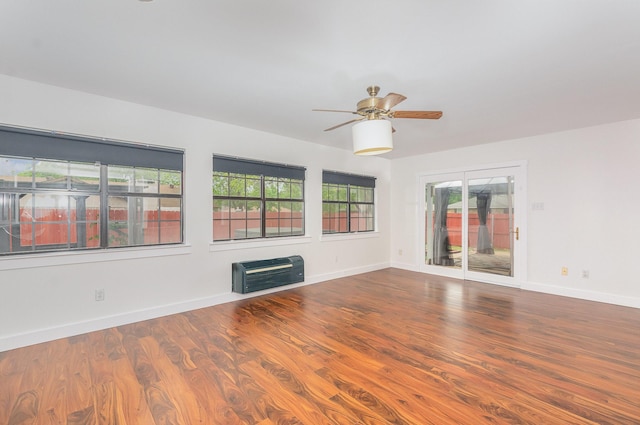 unfurnished room with a ceiling fan, a wealth of natural light, and wood finished floors