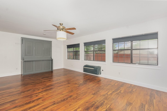 unfurnished room featuring baseboards, ceiling fan, and wood finished floors