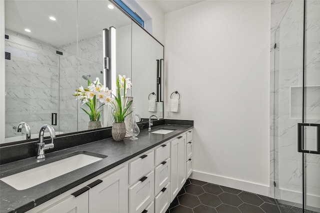 full bathroom with recessed lighting, a sink, a marble finish shower, and double vanity