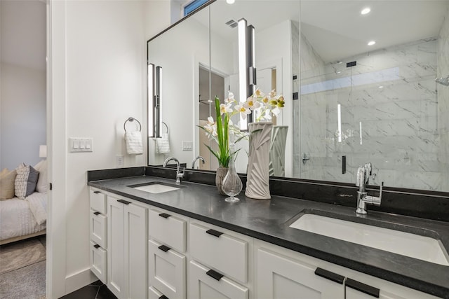 full bathroom featuring double vanity, recessed lighting, a marble finish shower, and a sink