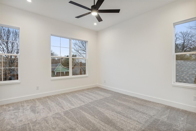 unfurnished room with carpet floors, baseboards, and ceiling fan