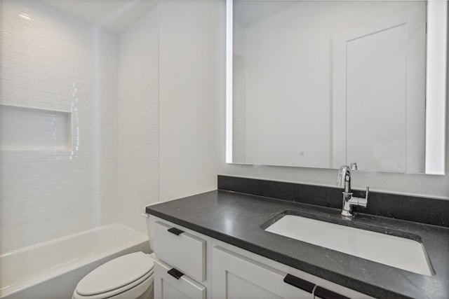 bathroom featuring vanity, washtub / shower combination, and toilet