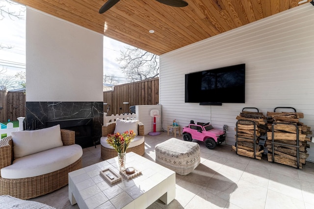 view of patio featuring fence and ceiling fan