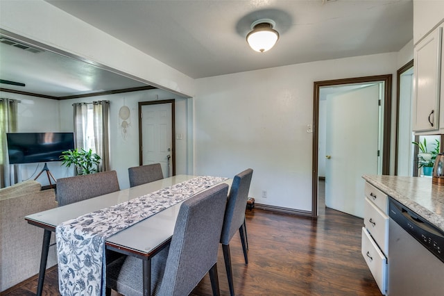 dining room with baseboards, dark wood finished floors, and visible vents