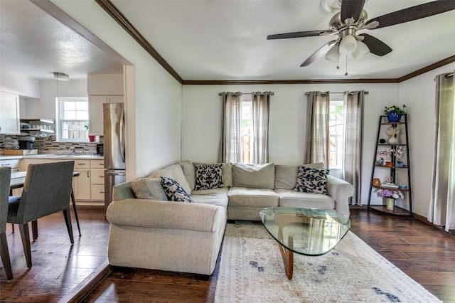 living room featuring ornamental molding, dark wood-style flooring, and ceiling fan