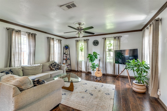 living area with visible vents, dark wood-style flooring, ceiling fan, and baseboards