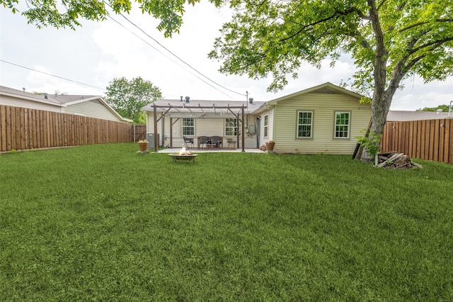 rear view of property featuring a pergola, a fenced backyard, an outdoor fire pit, and a yard